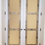 Custom antique brass interior door trim details. Glass centers. White lacquer frames. All hand made By: RBL Metals - Woodwork for this job - New Day Woodwork