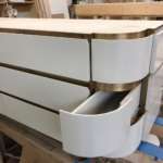 Custom light colored oil rub bronze (satin lacquer) in lays for a bathroom vanity. The satin lacquer and woodwork is by New Day Wood Work - RBL metals all metal fabrication for this project.