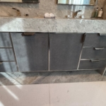 Custom polished stainless-steel frames and leather wrapped bathroom vanity. This piece has integrated hardware as well