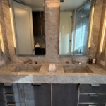 Custom polished stainless-steel frames and leather wrapped bathroom vanity. This piece has integrated hardware as well and add as well as the metal frames of the bathroom vanity's